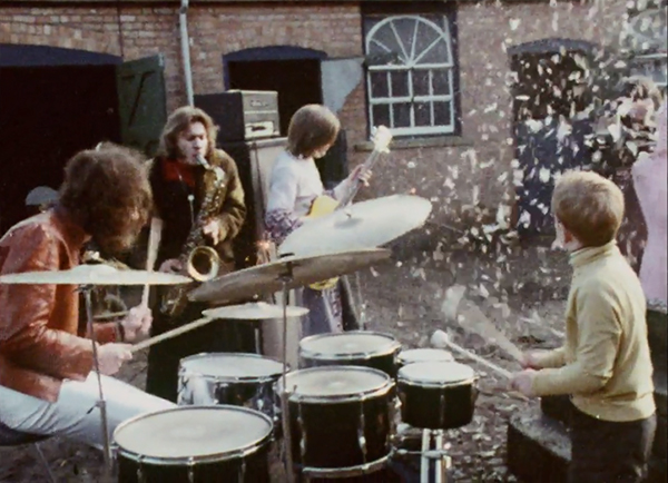 The Bonzo Dog Band playing in a farmyward.