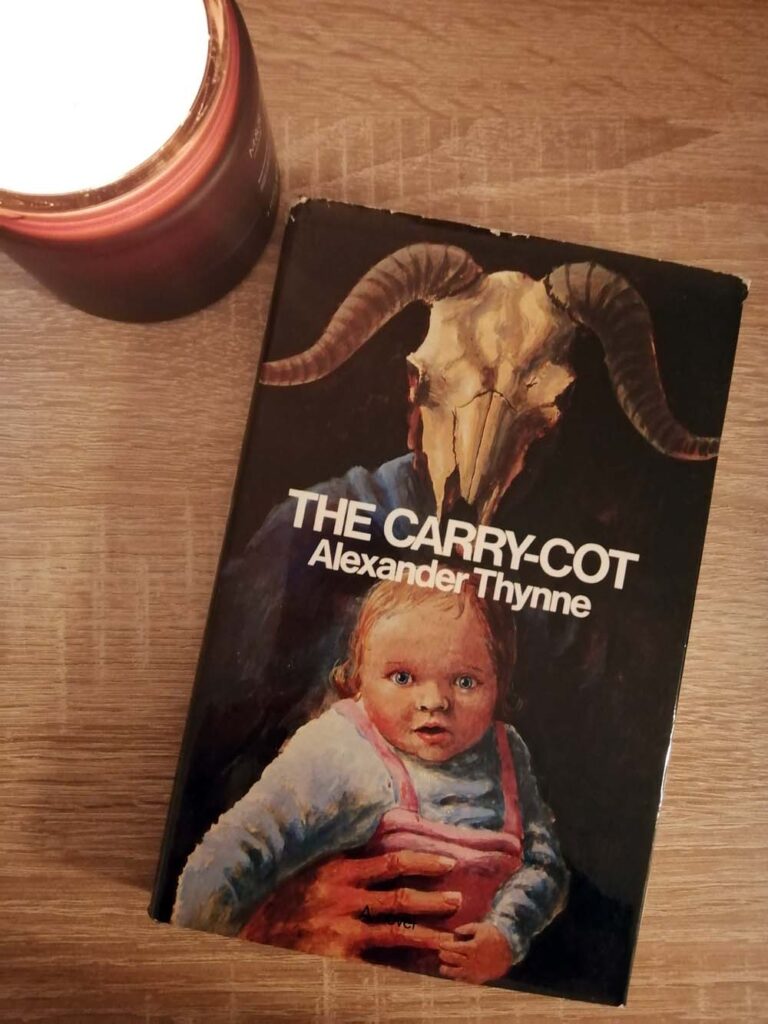 Cover of hardback novel, The Carry-Cot, with candle