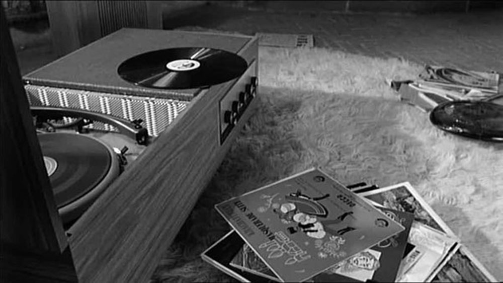 Vinyl records surrounded 1960s turntable