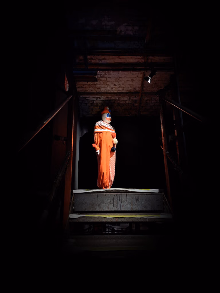 John Wayne Gacy's Pogo the Clown at the top of the stairs - Serial Killer World Tour London Exhibition.
